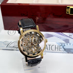 gold mechanical wrist watch with brown band