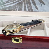 gold mechanical wrist watch with brown band